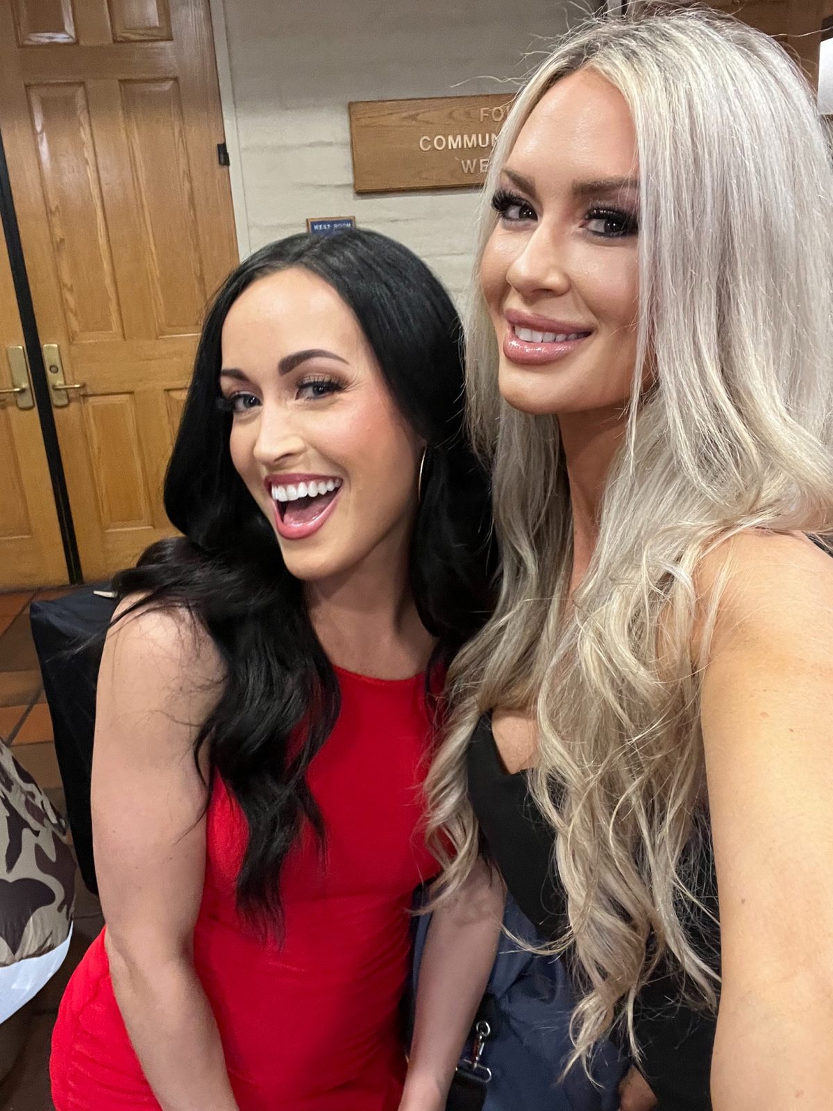 Two smiling Mandi's Models taking a close-up selfie at an event