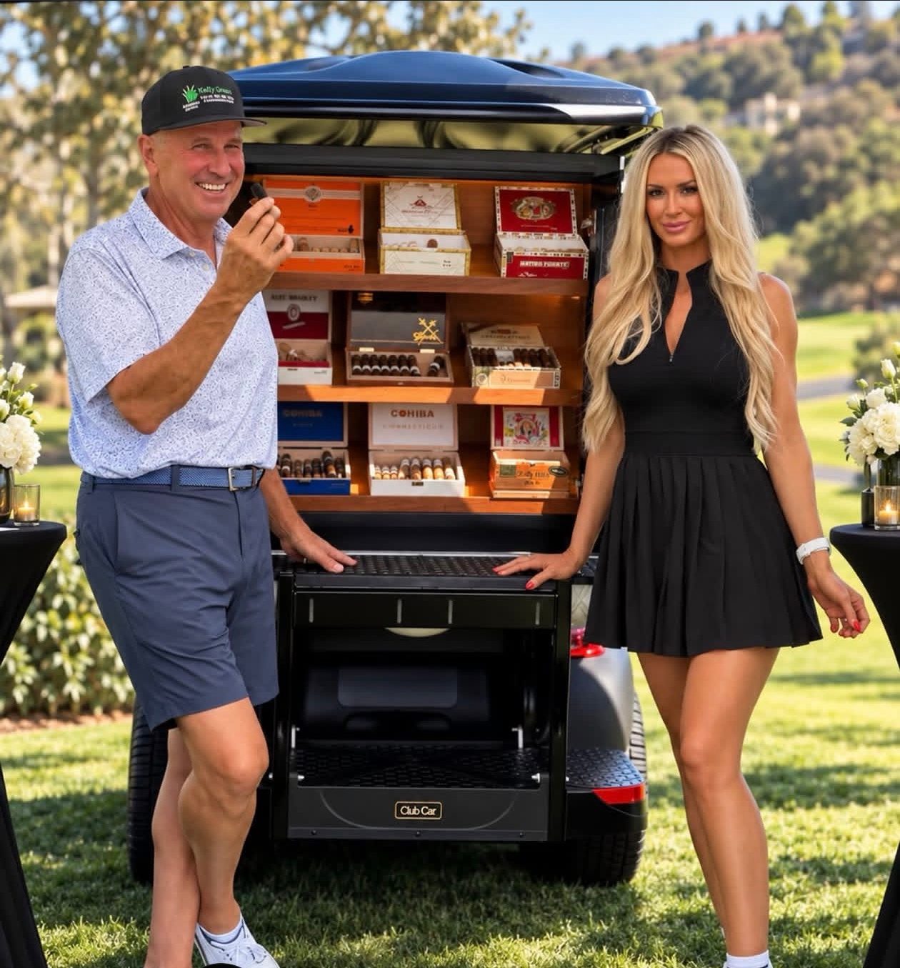 A Mandi's Model and a guest beside a golf cart fitted with a cigar humidor on a golf course